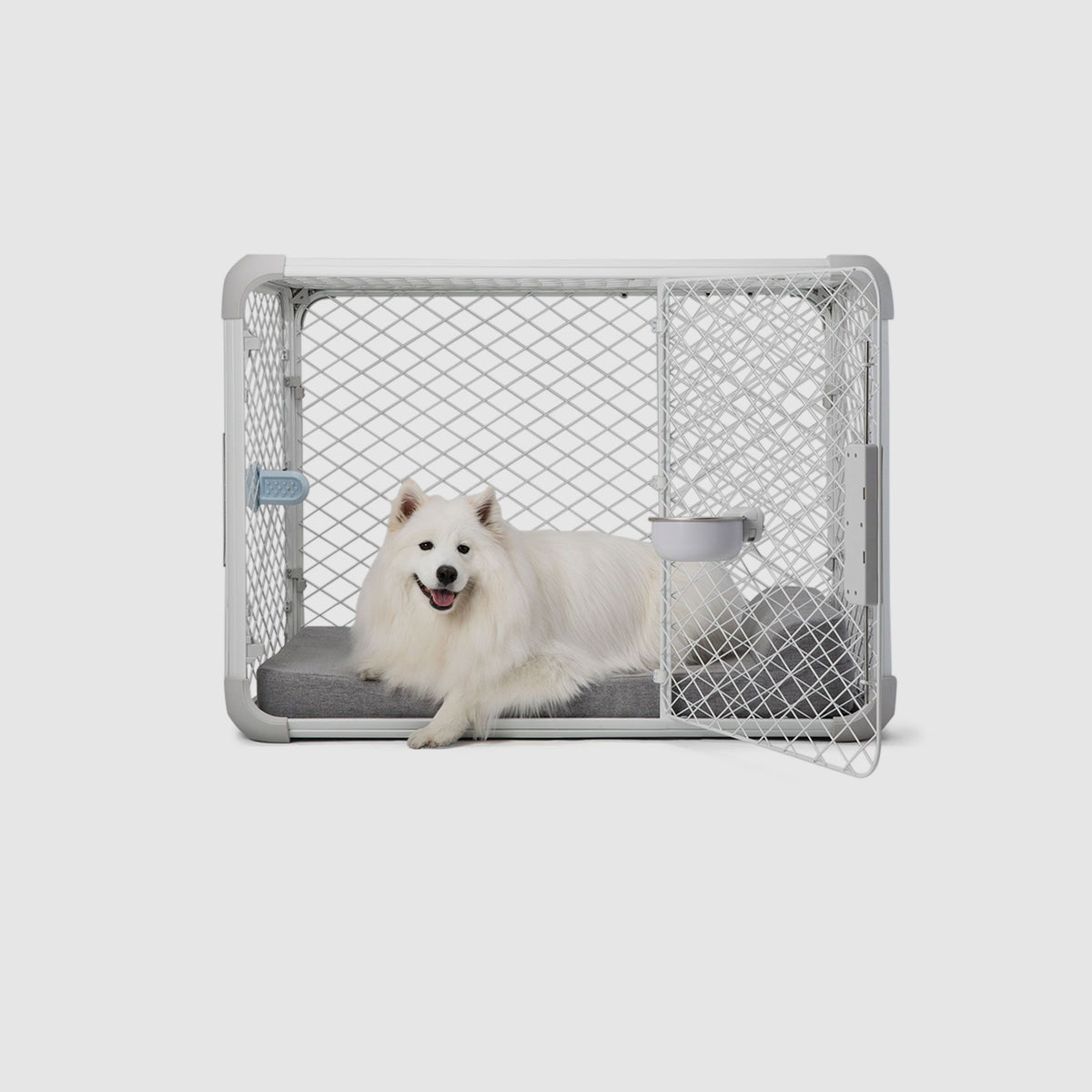 Side view of a dog laying on a Bolstr bed inside of an Evolv Dog Crate with open side door.