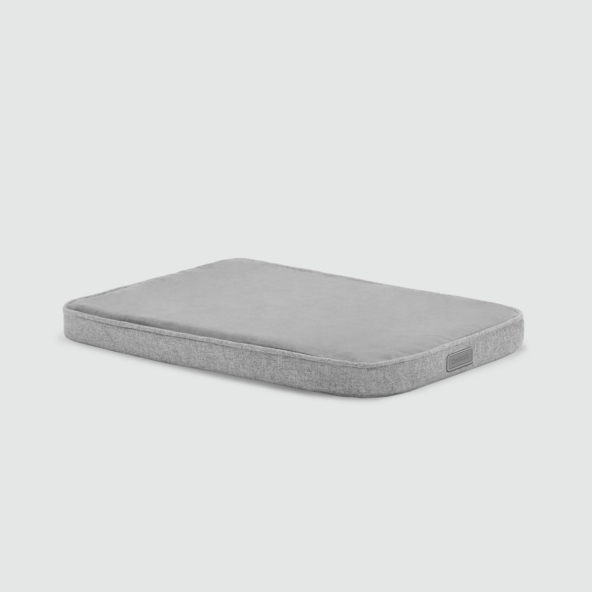A gray mattress with no sheets on it